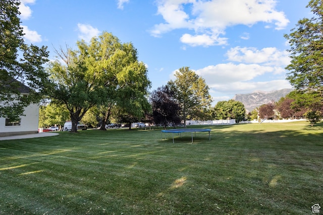 6373 W 10500 N, Highland, UT 84003 - view of green lawn with a trampoline and a mountain view