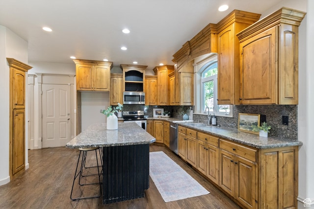 6373 W 10500 N, Highland, UT 84003 - kitchen with appliances with stainless steel finishes, a kitchen island, decorative backsplash, recessed lighting, and dark wood-style flooring