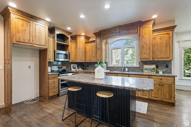 6373 W 10500 N, Highland, UT 84003 - kitchen with stainless steel appliances, dark wood finished floors, tasteful backsplash, a kitchen island, and a kitchen bar