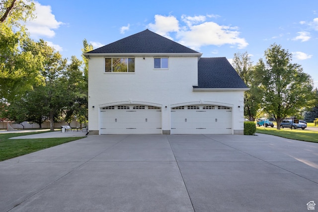 6373 W 10500 N, Highland, UT 84003 - view of side of home featuring concrete driveway, roof with shingles, and an attached garage