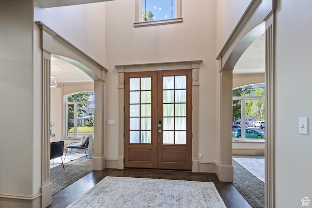 6373 W 10500 N, Highland, UT 84003 - entrance foyer with arched walkways, dark wood finished floors, french doors, plenty of natural light, and a towering ceiling