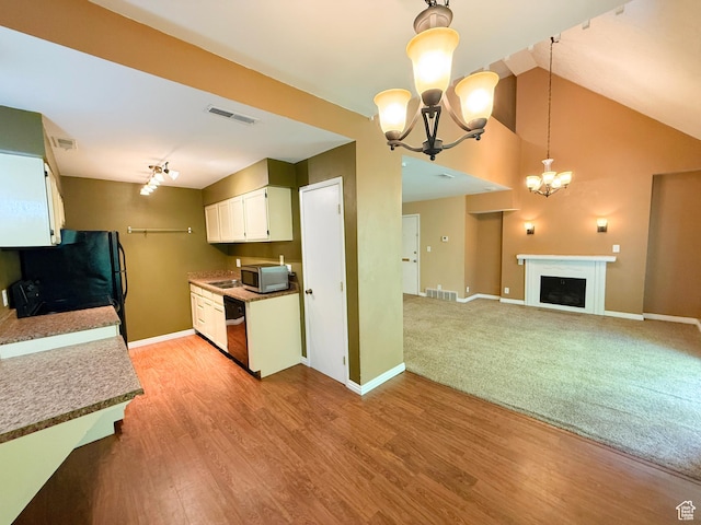 165 E 100 N Unit F, Logan, UT 84321 - kitchen with a chandelier, stainless steel microwave, white cabinetry, dishwasher, and track lighting