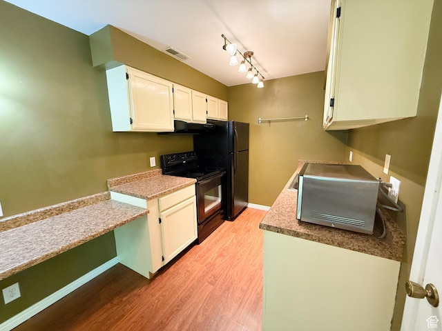 165 E 100 N Unit F, Logan, UT 84321 - kitchen with black appliances, light wood-type flooring, white cabinets, and under cabinet range hood