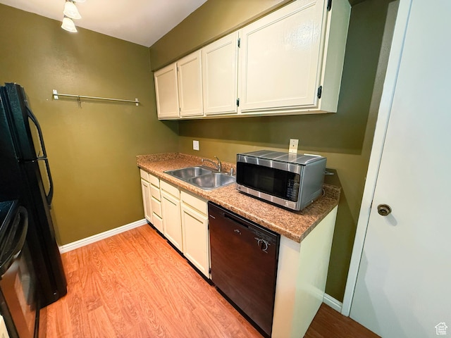 165 E 100 N Unit F, Logan, UT 84321 - kitchen with black dishwasher, stainless steel microwave, light wood-style flooring, and white cabinets