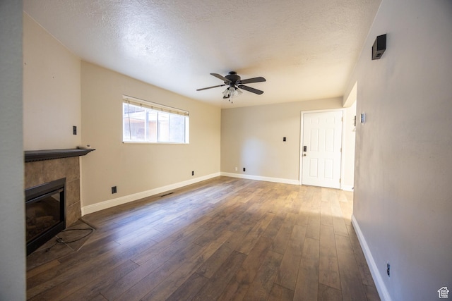 240 E 400 N Unit 28, Logan, UT 84321 - unfurnished living room with a ceiling fan, hardwood / wood-style floors, a textured ceiling, and a tiled fireplace