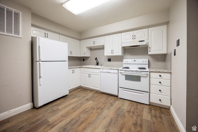 240 E 400 N Unit 28, Logan, UT 84321 - kitchen with white appliances, under cabinet range hood, wood finished floors, and tasteful backsplash