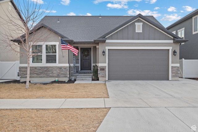1769 W Valcrest Dr, Saratoga Springs, UT 84045 - craftsman-style house with stone siding, concrete driveway, an attached garage, roof with shingles, and stucco siding