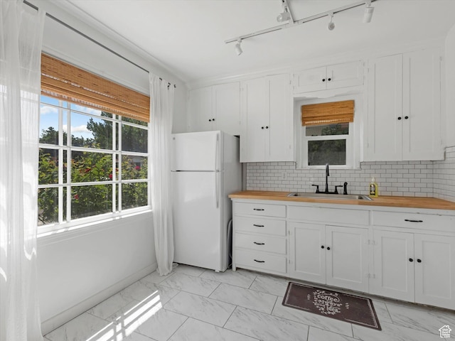 1332 S 200 E, Salt Lake City, UT 84115 - kitchen with freestanding refrigerator, butcher block counters, light marble finish floors, and plenty of natural light