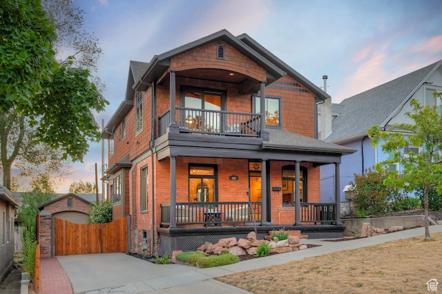 427 N J St E, Salt Lake City, UT 84103 - view of front of property featuring covered porch, a balcony, and brick siding
