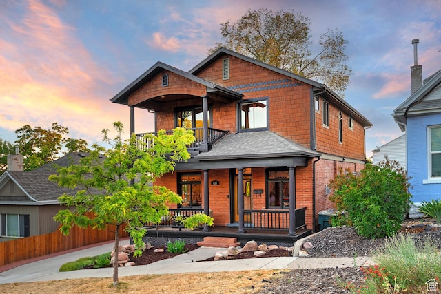 427 N J St E, Salt Lake City, UT 84103 - craftsman inspired home with a porch, a balcony, brick siding, and roof with shingles