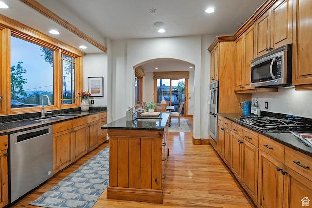 427 N J St E, Salt Lake City, UT 84103 - kitchen with appliances with stainless steel finishes, arched walkways, light wood-type flooring, dark stone counters, and recessed lighting