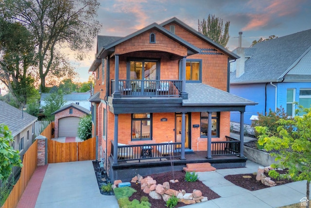 427 N J St E, Salt Lake City, UT 84103 - view of front of house with a porch, a detached garage, concrete driveway, a balcony, and an outbuilding