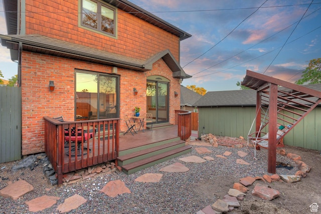427 N J St E, Salt Lake City, UT 84103 - back of house featuring a wooden deck, brick siding, and roof with shingles