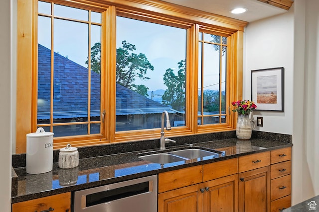 427 N J St E, Salt Lake City, UT 84103 - kitchen with stainless steel dishwasher, healthy amount of natural light, brown cabinets, and dark stone counters