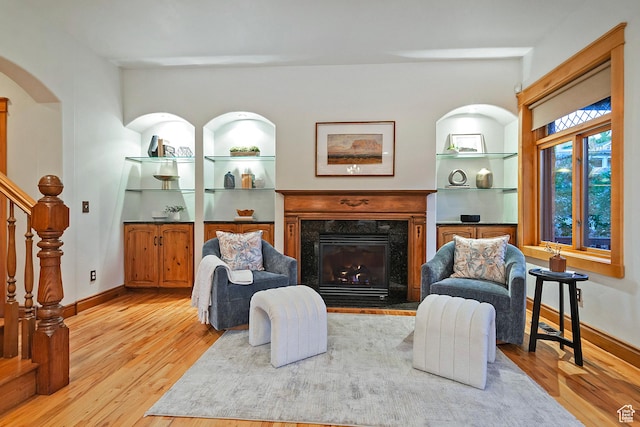 427 N J St E, Salt Lake City, UT 84103 - living area with wood finished floors, a high end fireplace, stairway, and arched walkways