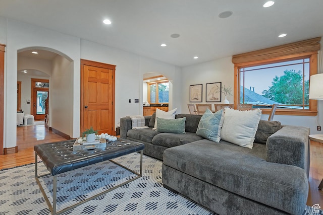 427 N J St E, Salt Lake City, UT 84103 - living room featuring arched walkways, recessed lighting, and light wood-style flooring