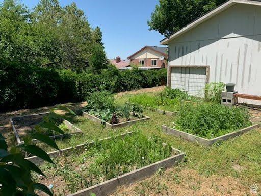 3018 E 4430 S, Salt Lake City, UT 84124 - view of yard featuring a garden and a garage