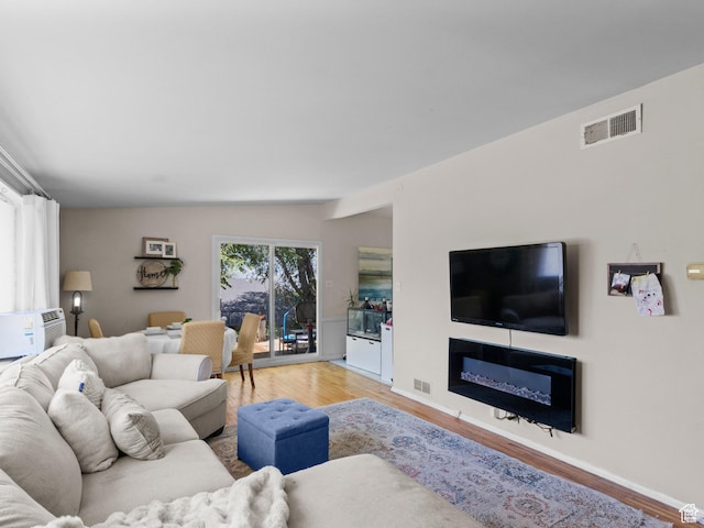 3018 E 4430 S, Salt Lake City, UT 84124 - living area with light wood-type flooring, a glass covered fireplace, and lofted ceiling