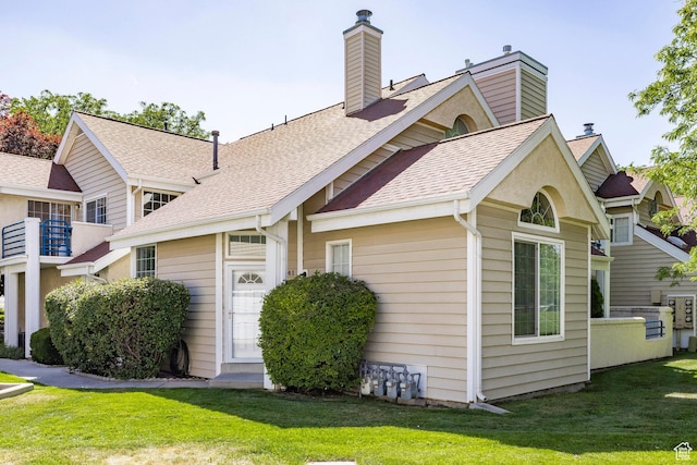 5441 S Spinnaker Row, Taylorsville, UT 84123 - view of front facade with a chimney, a front lawn, and roof with shingles