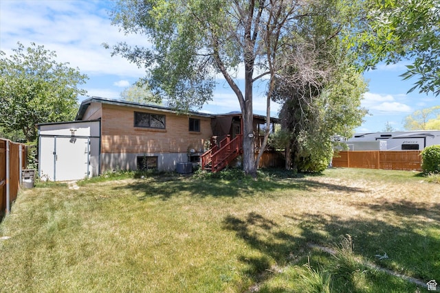 6709 W 3860 S, West Valley City, UT 84128 - rear view of house featuring stairs and a storage shed