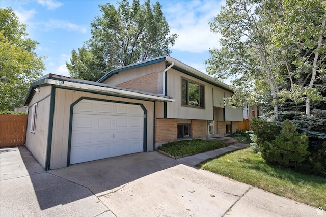 6709 W 3860 S, West Valley City, UT 84128 - view of front facade featuring brick siding, an attached garage, and concrete driveway