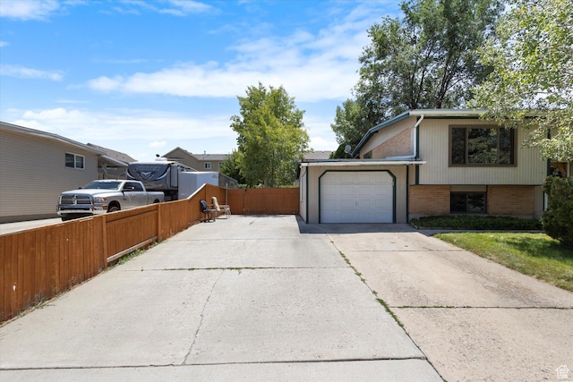 6709 W 3860 S, West Valley City, UT 84128 - view of side of home with driveway, brick siding, and an attached garage