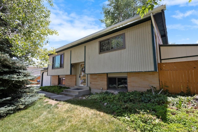 6709 W 3860 S, West Valley City, UT 84128 - raised ranch with brick siding and a front yard