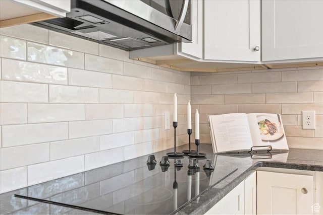 787 S 1680 E, Pleasant Grove, UT 84062 - kitchen with stainless steel microwave, backsplash, white cabinets, and dark stone countertops
