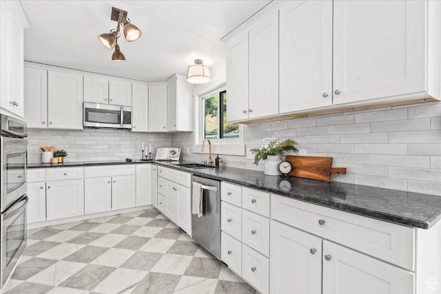 787 S 1680 E, Pleasant Grove, UT 84062 - kitchen featuring stainless steel appliances, white cabinetry, tasteful backsplash, and dark stone countertops