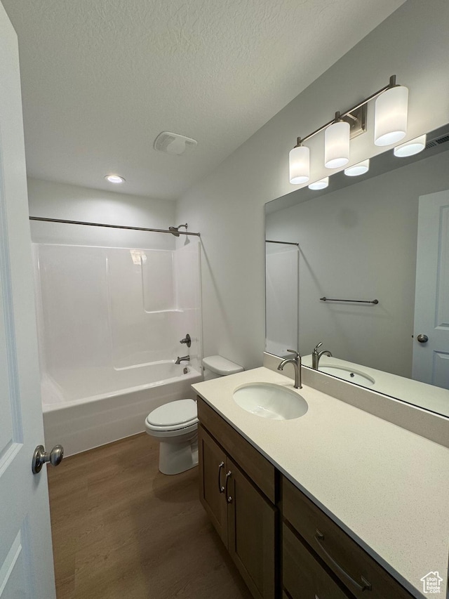 1456 N 1875 W Unit 147, Layton, UT 84041 - full bathroom featuring wood finished floors, vanity, washtub / shower combination, a textured ceiling, and recessed lighting