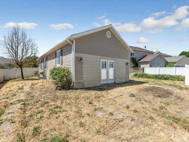 4049 E Dillons Dr N, Eagle Mountain, UT 84005 - back of house featuring french doors and a fenced backyard