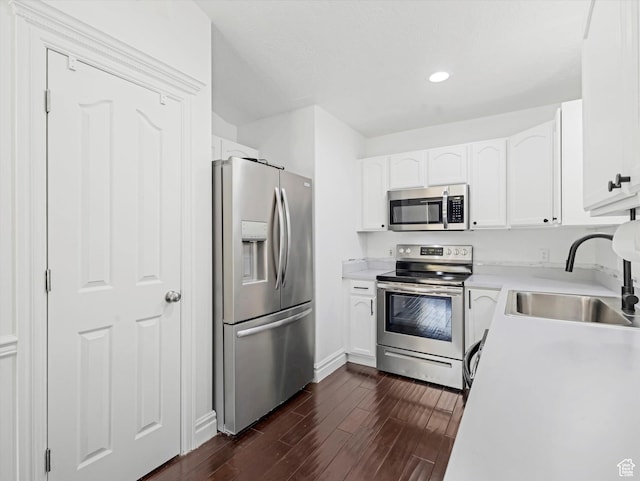 4049 E Dillons Dr N, Eagle Mountain, UT 84005 - kitchen with appliances with stainless steel finishes, dark wood-style floors, white cabinets, light countertops, and recessed lighting