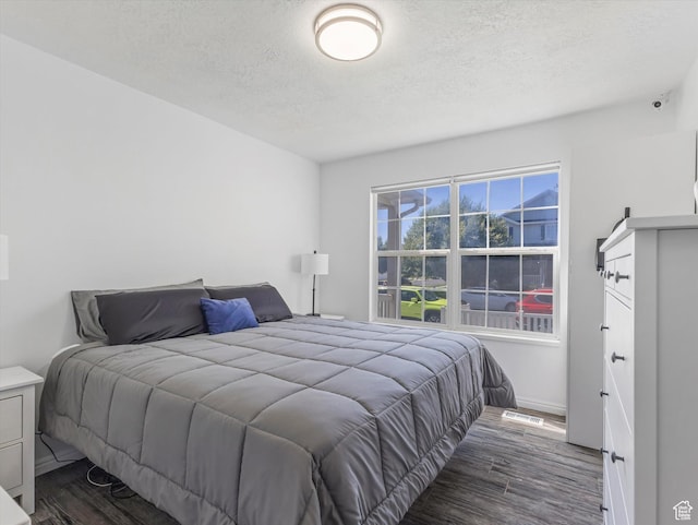 4049 E Dillons Dr N, Eagle Mountain, UT 84005 - bedroom with wood finished floors and a textured ceiling