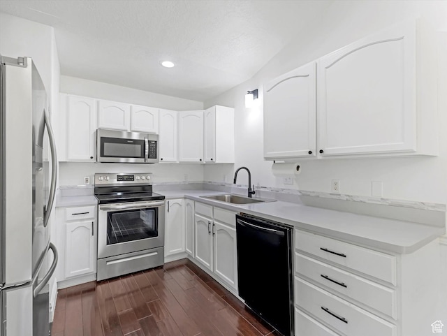 4049 E Dillons Dr N, Eagle Mountain, UT 84005 - kitchen with stainless steel appliances, recessed lighting, dark wood-type flooring, white cabinetry, and light countertops