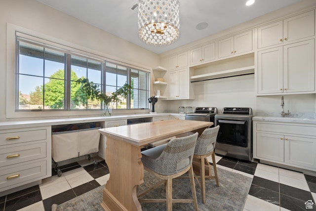2916 S 300 E, Washington, UT 84780 - kitchen with independent washer and dryer, open shelves, light countertops, a chandelier, and light tile patterned floors
