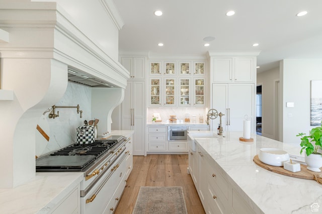 2916 S 300 E, Washington, UT 84780 - kitchen with light wood finished floors, decorative backsplash, white cabinets, recessed lighting, and light stone countertops