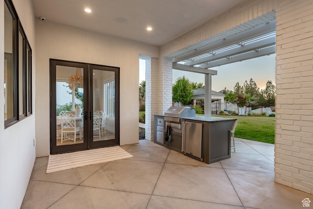 2916 S 300 E, Washington, UT 84780 - patio terrace at dusk featuring an outdoor kitchen, french doors, and a patio area