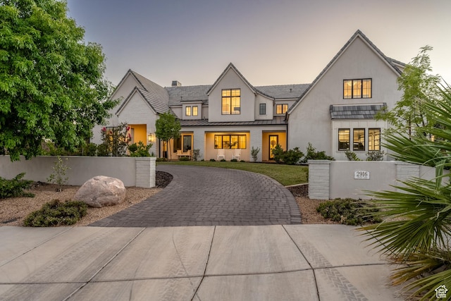 2916 S 300 E, Washington, UT 84780 - view of front facade featuring a standing seam roof, curved driveway, stucco siding, and a metal roof