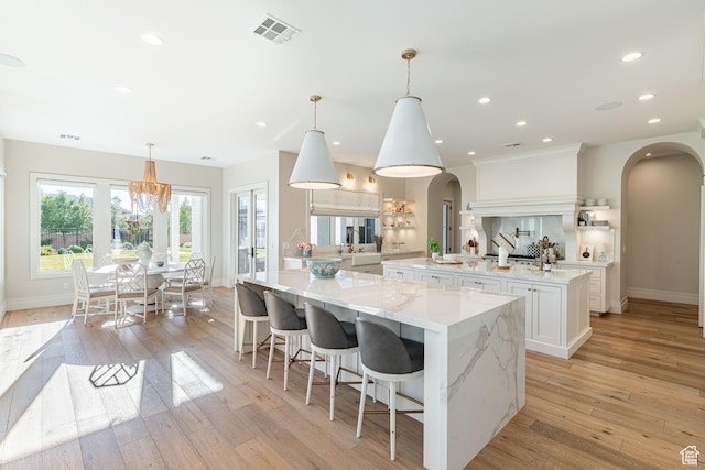 2916 S 300 E, Washington, UT 84780 - kitchen featuring arched walkways, a large island, white cabinets, light wood-style floors, and recessed lighting