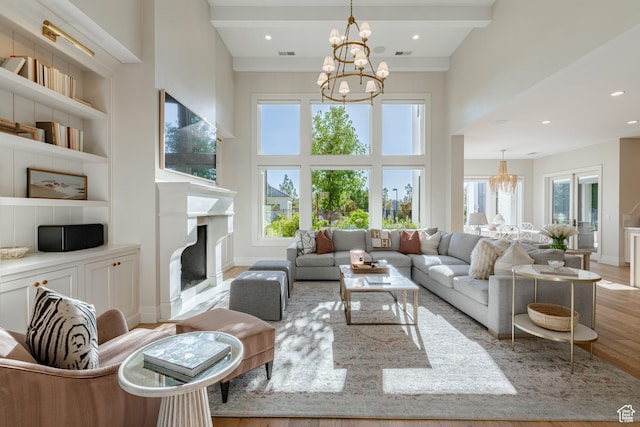 2916 S 300 E, Washington, UT 84780 - living room with a chandelier, light wood-type flooring, built in shelves, a high ceiling, and a high end fireplace