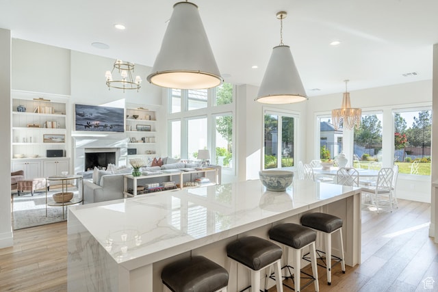 2916 S 300 E, Washington, UT 84780 - kitchen with a chandelier, plenty of natural light, light stone countertops, light wood-style floors, and recessed lighting