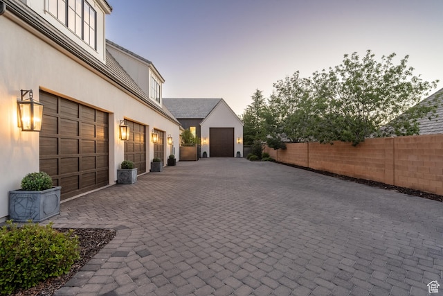 2916 S 300 E, Washington, UT 84780 - garage at dusk featuring decorative driveway