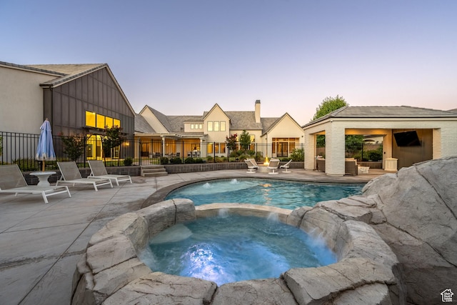 2916 S 300 E, Washington, UT 84780 - pool at dusk featuring a pool with connected hot tub and a patio