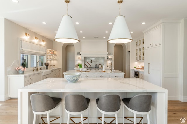 2916 S 300 E, Washington, UT 84780 - kitchen featuring arched walkways, a large island, backsplash, light wood finished floors, and recessed lighting