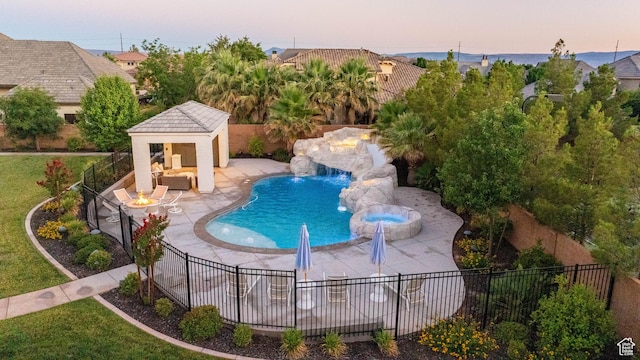 2916 S 300 E, Washington, UT 84780 - view of swimming pool featuring a patio area, an outbuilding, a storage structure, a pool with connected hot tub, and an outdoor living space with a fire pit
