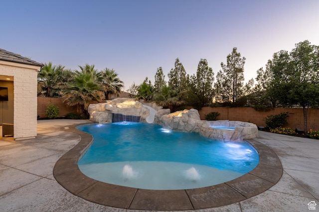 2916 S 300 E, Washington, UT 84780 - pool at dusk with a fenced backyard, a pool with connected hot tub, and a patio