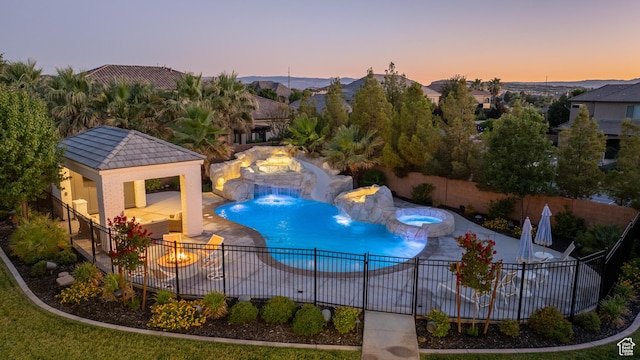 2916 S 300 E, Washington, UT 84780 - pool at dusk with a gazebo, a fire pit, a fenced backyard, and a patio