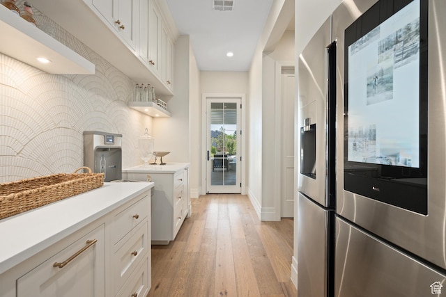 2916 S 300 E, Washington, UT 84780 - kitchen featuring stainless steel fridge, light wood finished floors, light countertops, white cabinetry, and backsplash