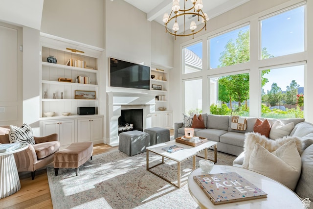 2916 S 300 E, Washington, UT 84780 - living area featuring a towering ceiling, a chandelier, wood finished floors, a high end fireplace, and built in shelves