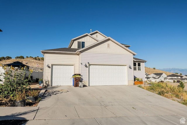 7390 N Pawnee Rd, Eagle Mountain, UT 84005 - view of front of house with a garage, driveway, and a mountain view